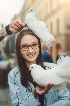 White doves in the hands of a girl. Tour of St. Petersburg.の写真素材