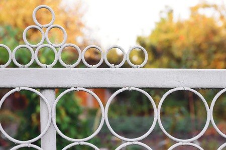Fragment of a white metal fence with round elements.の写真素材