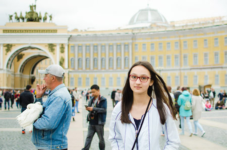Saint Petersburg, RUSSIA - July 08, 2018: Tourists walk along the Palace Square of St. Petersburg. Beautiful tourist girl.のeditorial素材