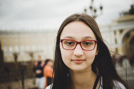 Portrait of a beautiful brunette girl with glasses. Toned photo, instaram style.の写真素材