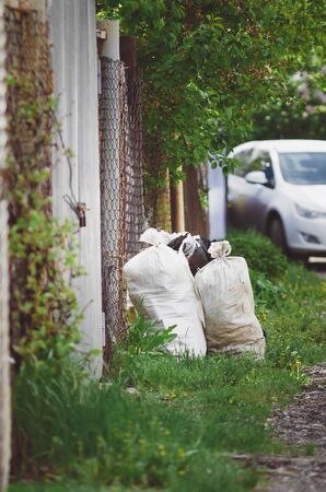 Bagging garbage in country houses, Russia. . Vertical photograph.の写真素材