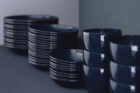 Stylish modern dishes in black. Kitchen set with clean utensils, close-up. The concept of modern cuisine. 3d render.の写真素材