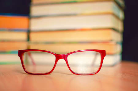 Glasses for sight on the background of books.の写真素材