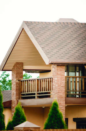 Fragment of a beautiful country house with a balcony.の写真素材