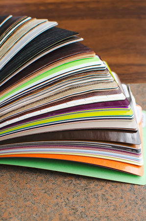 Glossy PVC plastic cards to select the color of furniture lined fan close-up. Vertical photography.