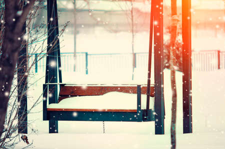 Empty swing in the park on a winter day. Beautiful winter landscape.の写真素材