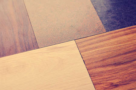 Wood floor texture Samples of laminate and vinyl floor tiles on oak wood background for new construction or renovation of a building or house.の写真素材