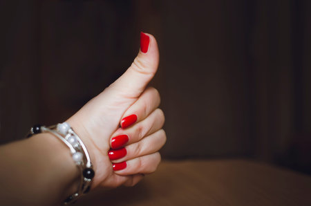 The female's hand shows a gesture of approval. Thumbs up. The hand shows gesture class. Everything...
