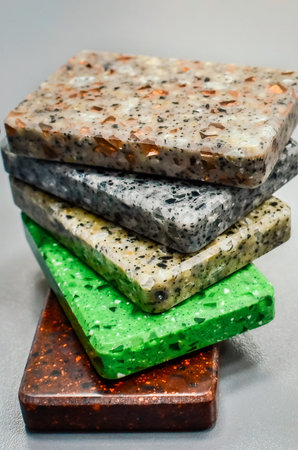 Samples of multicolored acrylic stone, vertical photography.