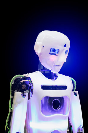 Humanoid robot on a dark background. Vertical photography.