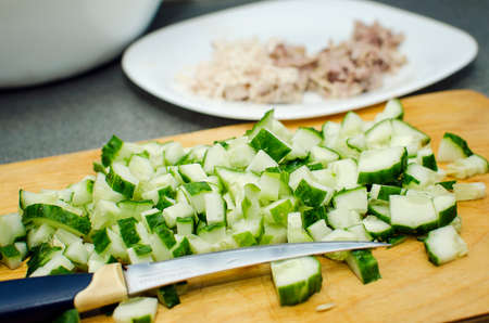 Fresh cucumbers are cut into cubes. Salad ingredients. Healthy food.の写真素材