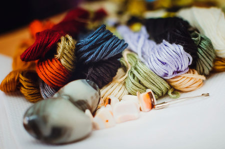 Close up shot of vibrant colorful embroidery floss cross stitch string.