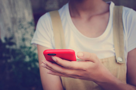 The phone is in the hands of the girl. Modern technologies.