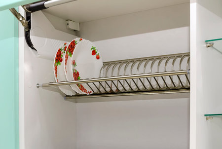 Plates are drying in dish-drying cabinet in kitchen.の写真素材