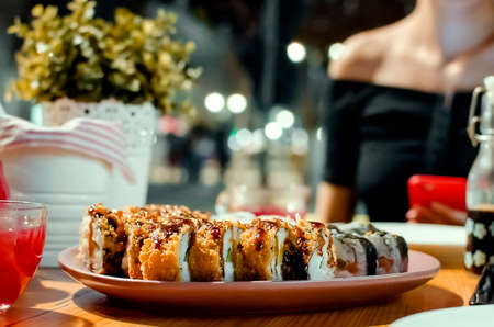 Maki ands rolls with tuna, salmon, shrimp and avocado, assorted sushi in the cafe. japanese cuisine concept Close-up, selective focus.の写真素材