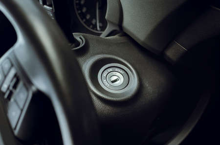 Ignition lock on the steering wheel, close-up. Starting and Stopping Car Engine with Ignition Keyの写真素材