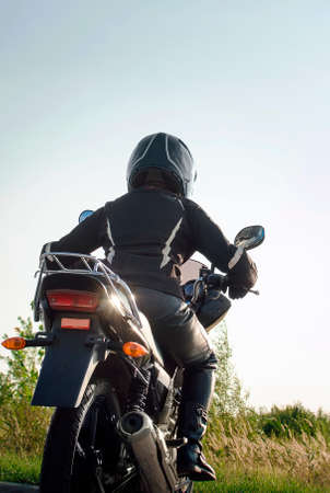 Woman biker travels on a motorcycle. Vertical photography.の写真素材