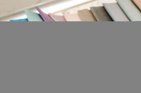 Woman chooses scraps of colored tissue on table close up