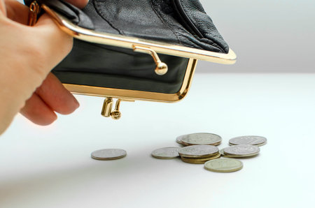 An empty wallet in hands close-up. Russian coins. Poverty, misery, little wages.