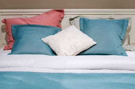pillows, duvet and duvet case on a bed. multicolored bed linen. Close-up cozy home background.の写真素材