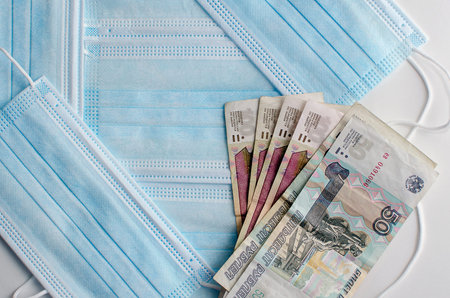 Face mask and Russian banknotes - trading concept during virus outbreak.