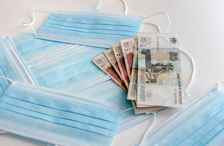 Medical face masks and money. Surgical face mask. Russian banknotes and Medical face masks.の写真素材