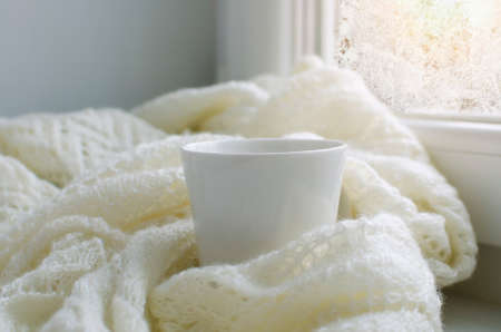 Cup of tea on White knitted plaid.の写真素材