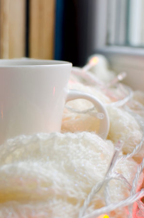Cup of tea on White knitted plaid. Beautiful cozy background. Vertical photography.の写真素材