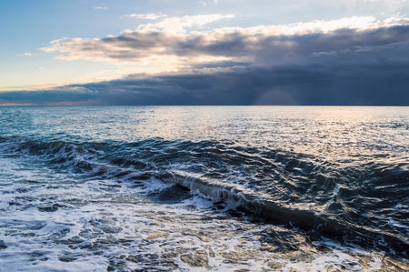 Sea blue waves under a cloudy sky. beautiful seascape.