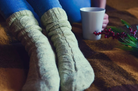 Close-up of legs dressed in blue jeans and knitted socks. close-up.の写真素材