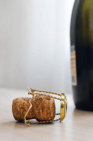 Bottle from champagne and cork on the table, Close up. The use of alcoholic beverages. vertical...