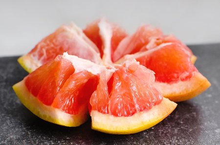 broken red grapefruit close-up. Lots of vitamins in fruits. Health food.
