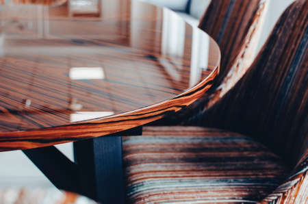 Brown Wooden polished Dining room table and chairs. Close-up, selective focus.の写真素材