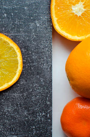 Sliced orange slice on black vintage background. vertical photography.の写真素材