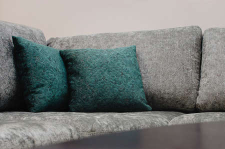 Close up fabric sofa with stylized pillows and throwの写真素材