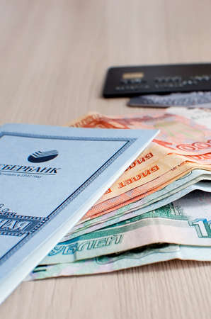 Saratov, RUSSIA - March 27: Russian money, a savings book and bank cards are on the table. vertical photography.のeditorial素材