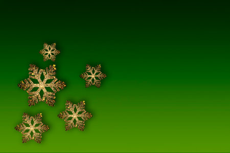 Golden beautiful snowflakes on a green background. Place for text, copyspace. Beautiful New Year's card.の写真素材