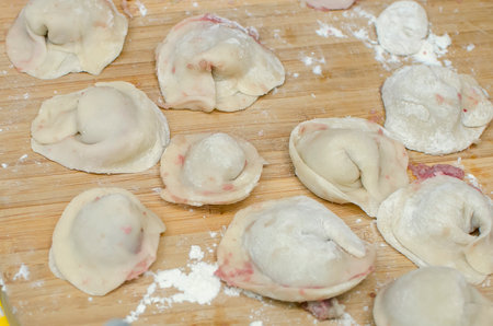 Homemade dumplings lie on a cutting board. Close-up, selective focus.の写真素材