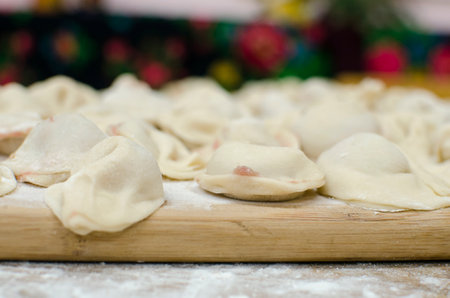 Homemade raw pastry dumplings with meat filling called pelmeniの写真素材