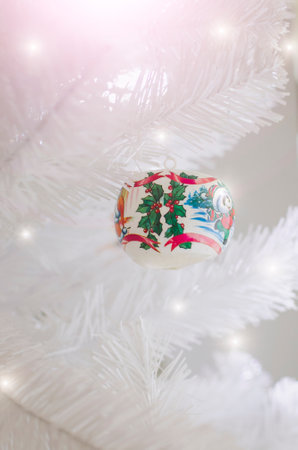 New Year card. White Christmas tree decorated with colorful toys. Vertical photography.の写真素材
