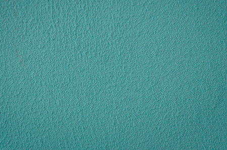 old plastered wall surface for rough textured background or wallpaper of bright blue color, close-upの写真素材