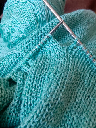 Wool yarn in blue color with metal needles. Vertical photography.の写真素材
