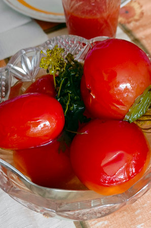 Image of red pickled canned tomatoes on a plate. above view.の写真素材