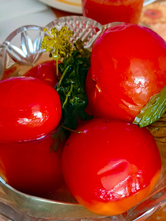 Salting. Juicy pickled tomatoes in a plate. Vertical photography.の写真素材