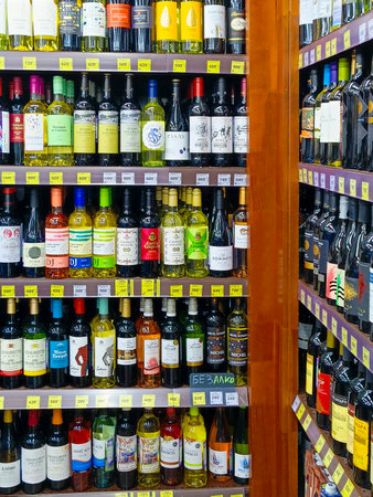 Sochi, RUSSIA - May 5, 2024: Collection of wines in the store of alcohol. Bottles of various wines are beautifully on the rack inside a Supermarket for sale.の写真素材
