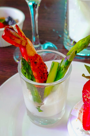 Tiger shrimp with asparagus in sauce. Beautiful presentation of the dish. Vertical photography.の写真素材