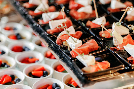Rolls with salted salmon, foie gras with fruits and other delicious delicacies. Beautiful serving in a restaurant, buffet.の写真素材