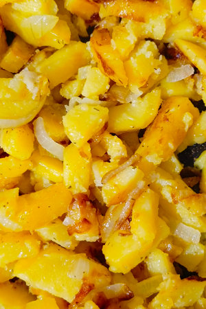 Fried potatoes with onions. Close-up, top view. Vertical photo.の写真素材
