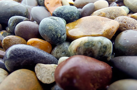 Abstract background with pebbles - round sea stones. Close-up of wet sea pebbles.の写真素材