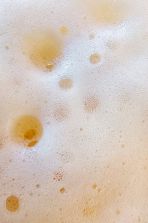 yellow foam texture- bubbles abstract background on the water